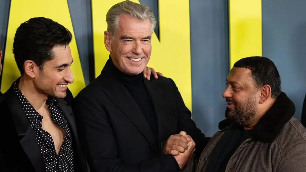 Pierce Brosnan, Prince Naz, and the embrace that never happened.