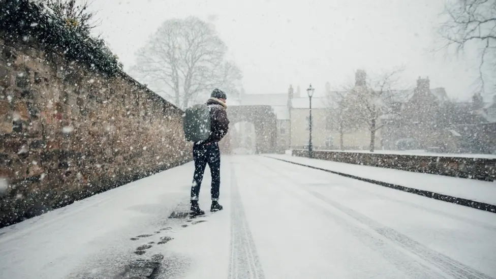 Schools closed and travel disrupted in parts of UK after heavy snow